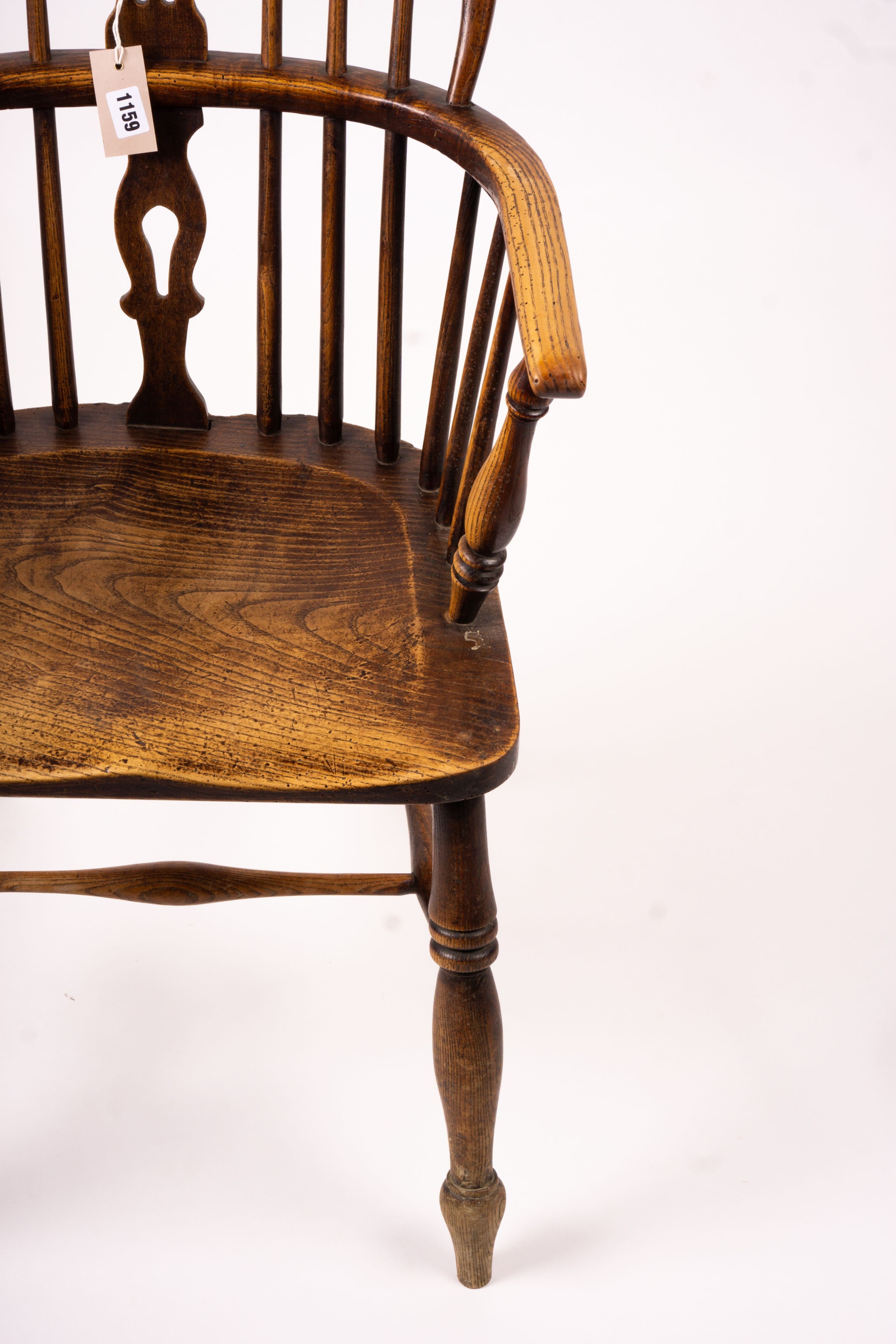 A mid 19th century ash and elm Derbyshire area Windsor elbow chair, together with a 19th century yew and elm Windsor wheel back chair with crinoline stretcher